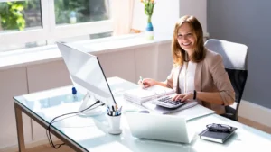 Female accountant with grey suit calculating payroll expenses for a client.