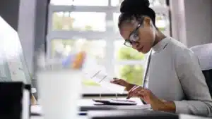 Women in accounting office prepares financial strategies for a Witney-based business.