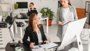 Accounting colleagues in the office discussing a business's cashflow.