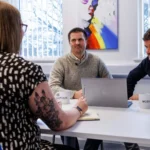 Accountants from Modus sitting around a table in the Abingdon office discussing tax.