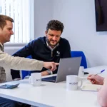 Accountants at Modus discussing something in the office.